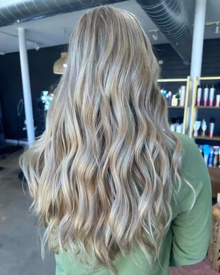 Soft dimensional blonde hair color with blended highlights and natural root melt at Studio 303