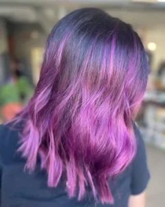 Purple and violet fashion hair color with blended tones and soft movement at Studio 303 in Englewood, CO
