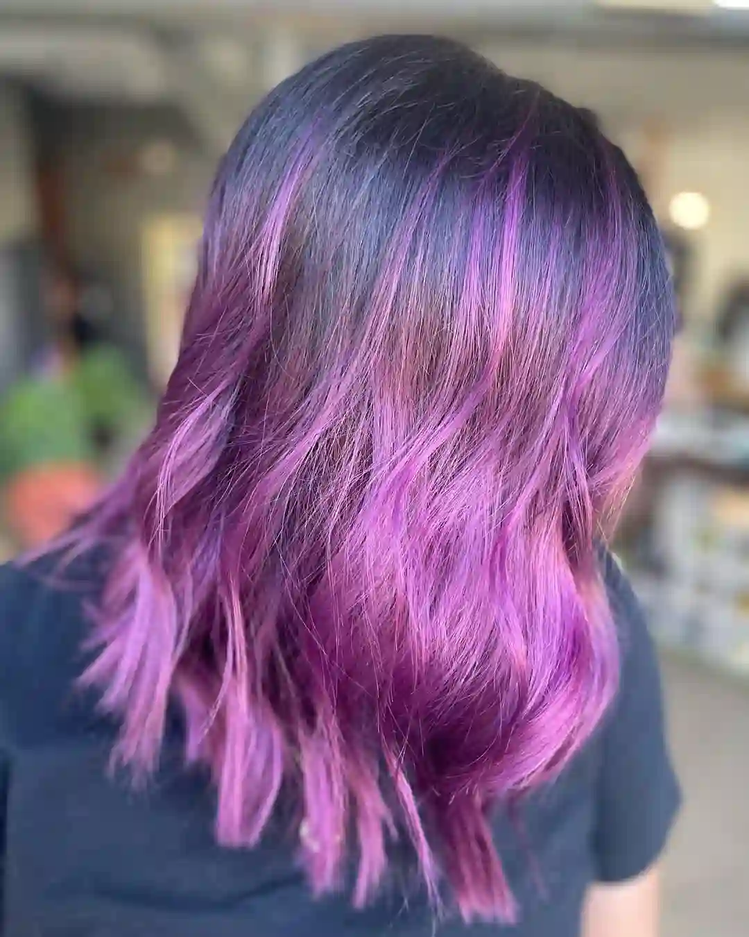 Purple and violet fashion hair color with blended tones and soft movement at Studio 303 in Englewood, CO