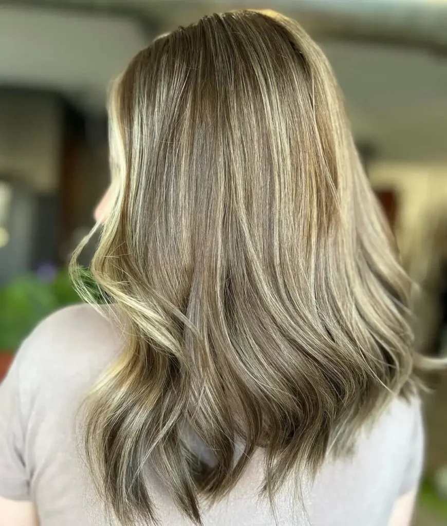 Lived-in blonde balayage with soft dimension and natural grow-out