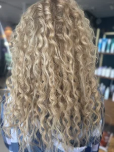 Finished curly hairstyle with defined, balanced texture created at Studio 303 hair salon