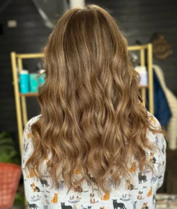 Dimensional lived in hair color with soft waves and natural grow out, created at Studio 303 hair salon in Englewood, Colorado.