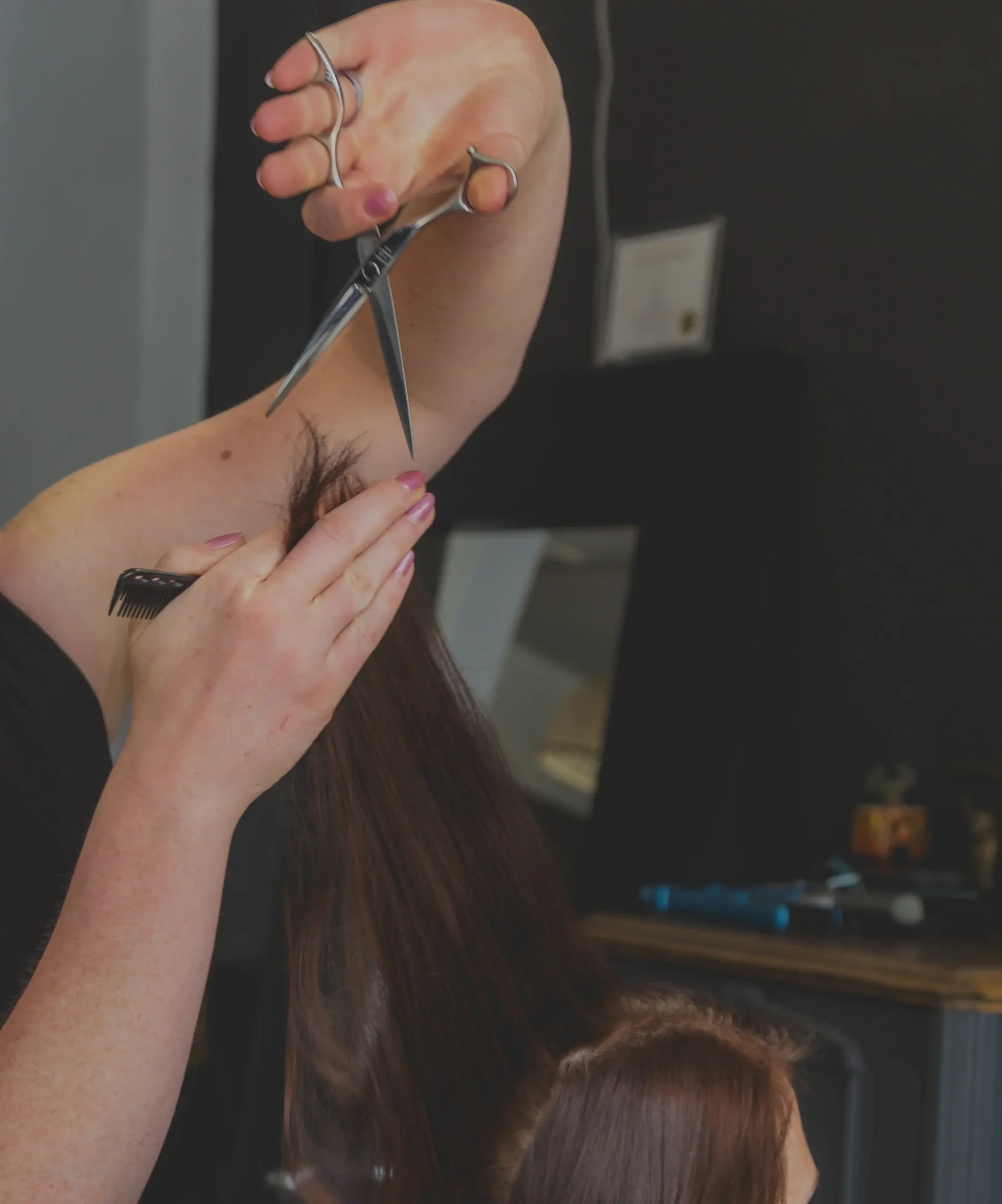Precision haircut in progress at Studio 303, showcasing expert cutting technique and attention to detail