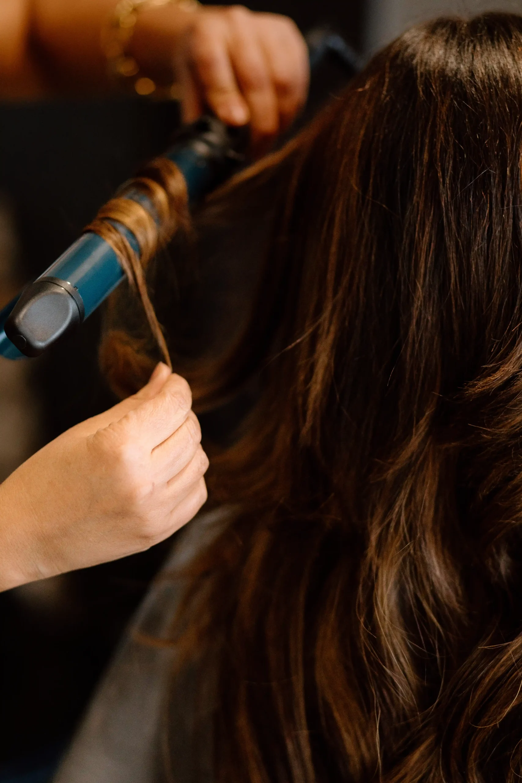 Precision heat styling to create smooth, long-lasting movement in the hair at Studio 303 in Englewood, Colorado