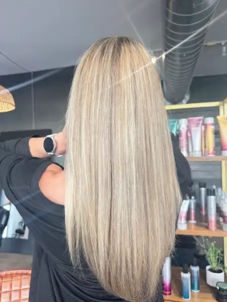 Balayage blonde highlights on long straight hair at Studio 303 Englewood CO