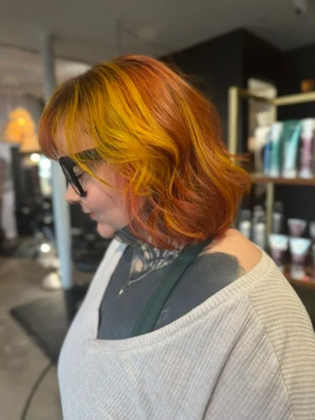 Copper orange vivid color on wavy bob at Studio 303 hair salon Englewood CO