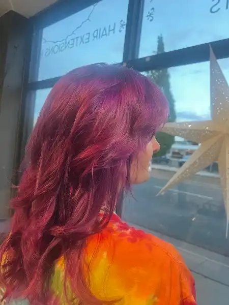 Magenta red vivid hair color with long layers at Studio 303 salon Englewood CO