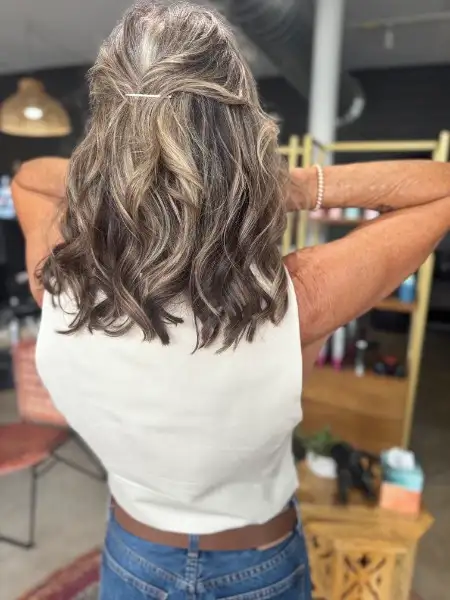 Silver and grey highlights on wavy lob at Studio 303 hair salon Englewood CO
