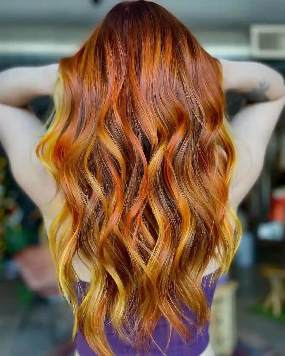 Copper and golden orange vivid hair color at Studio 303 in Englewood, CO.