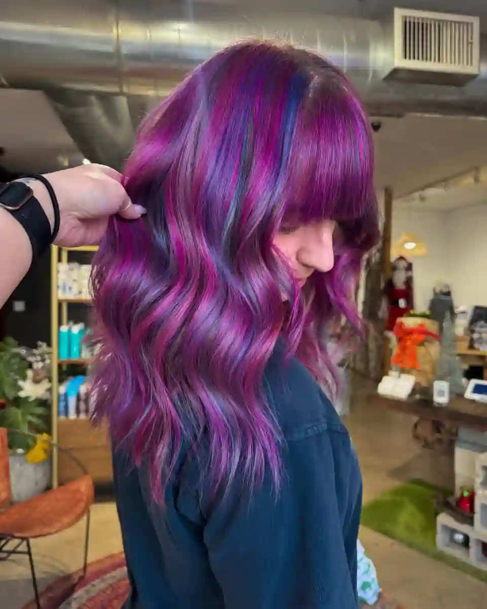 Purple vivid hair color with blue highlights at Studio 303 in Englewood, CO.