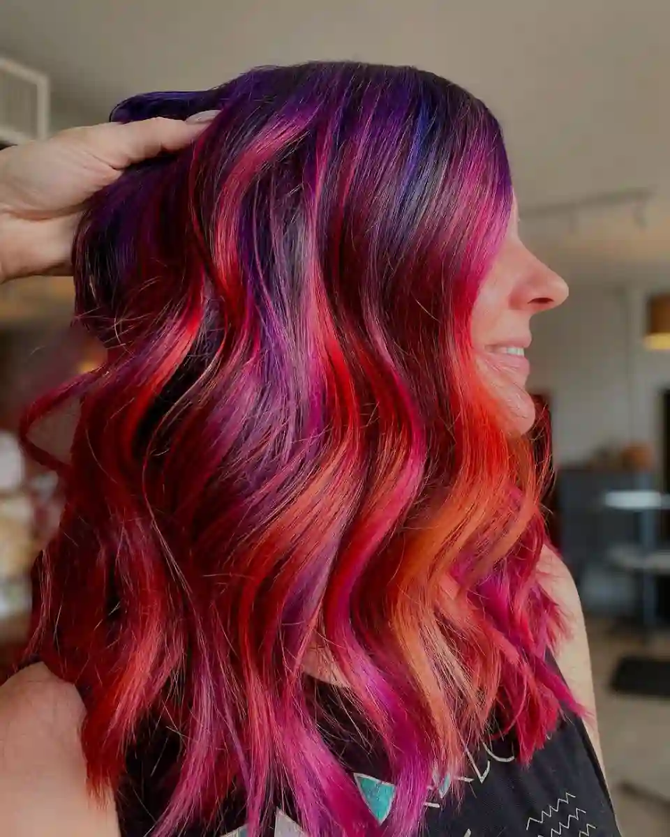 Red, pink, and violet vivid hair color at Studio 303 in Englewood, CO.